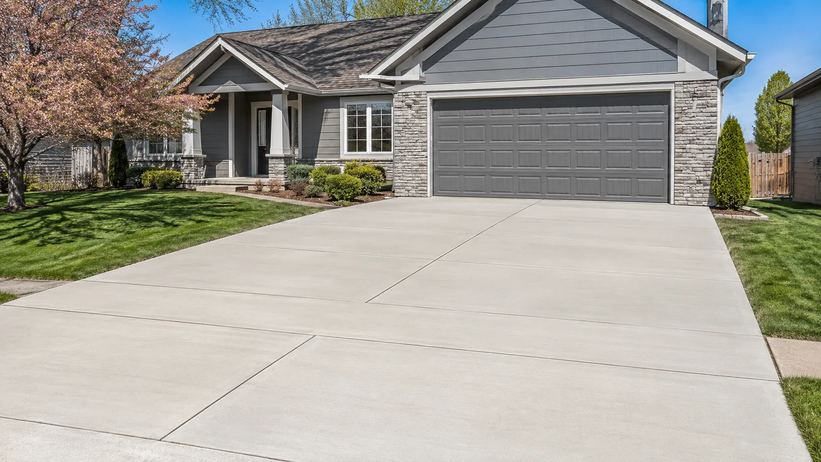 Newly replaced concrete driveway in front of a residential home